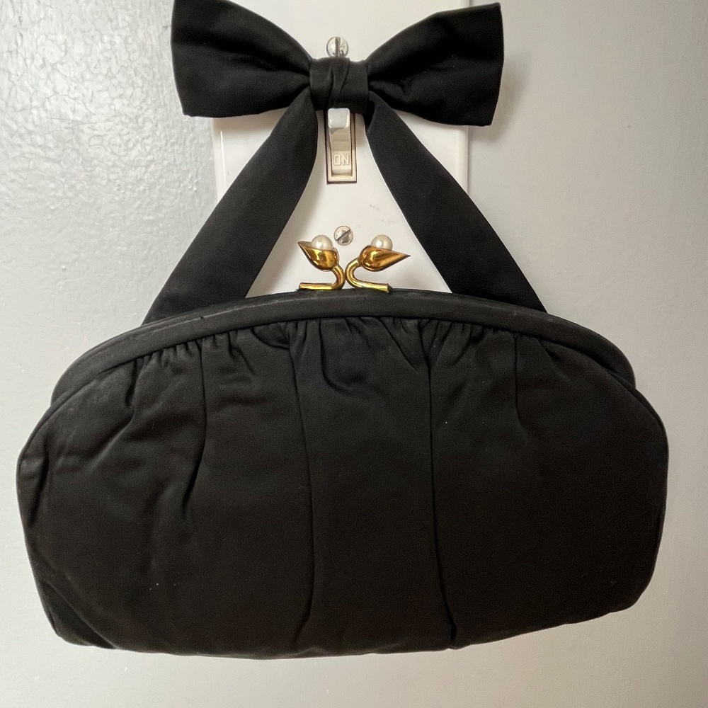 Black clutch with with gold accents and pearl